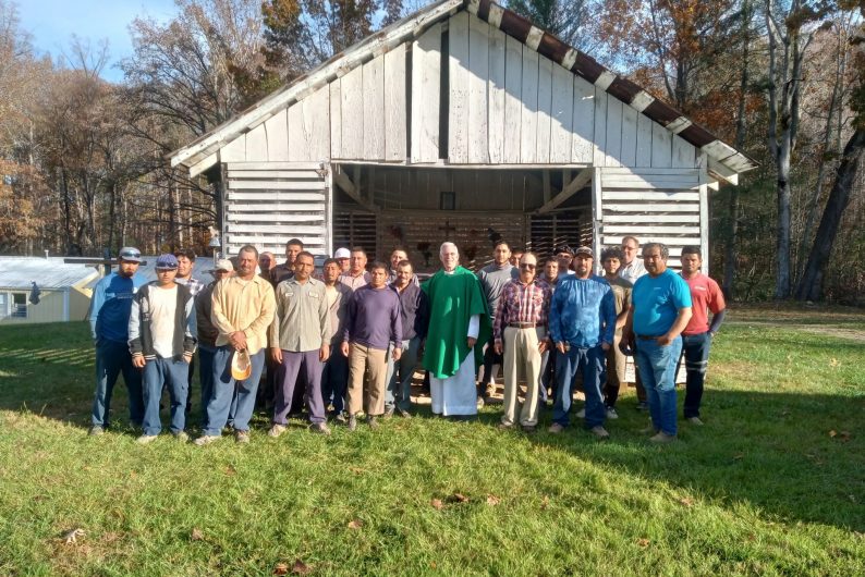 Fr. Tom Charters celebrates Mass with the migrant farm workers in Erwin at the end of the season. The Mass was delayed because of the historic and devastating flooding in Erwin. Photo courtesy of Lorena Reynoso.